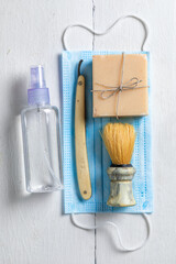 Antique barber equipment with razor, brush and mask in pandemic