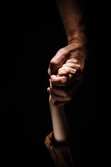 The child holds his father hand.