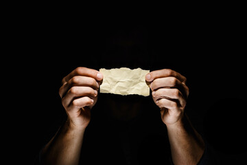 Sheet of paper in male hands.