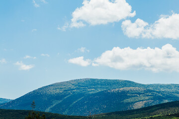landscape mountain with green forest and blue sky with clouds