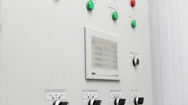 Close up of indicator lights on control panel at the factory. Media. Industrial plant boiler room control panel with buttons and signal lamps.