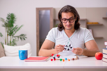 Young male student preparing for exams at home
