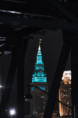 Cleveland ohio skyline at night with a ship on the cuyahoga river