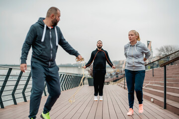 Group of friends doing fitness exercise outdoor