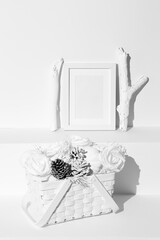 Minimal winter composition. Basket with white cones, roses and pumpkin. Frame mock up design. Still life art