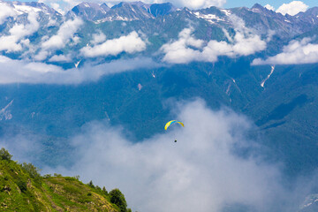 Beautiful mountain landscape at Caucasus mountains with hang glider.