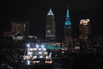 Cleveland ohio skyline at night with a ship on the cuyahoga river