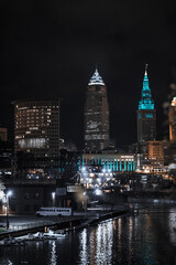 Fototapeta na wymiar Cleveland ohio skyline at night with a ship on the cuyahoga river