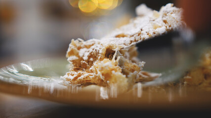 Tasty dessert. Slice of Napoleon cream cake, made from puff pastry, lies on a plate on a table in a restaurant