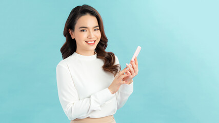 Portrait of beautiful woman using smartphone, isolated