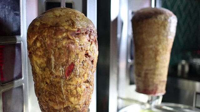 Shawarma. Closeup picture of stacked meat roasting