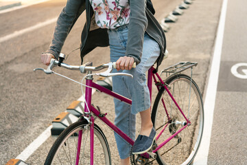unrecognizable girl with bicycle at the bike path