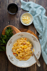 A typical neapolitan dish, potato and pasta, with bacon and tomatoes.