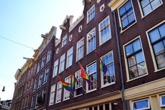 LGBT+ flags on a building facade in Amsterdam, The Netherlands. © Zhanko