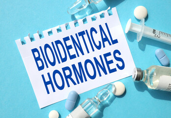 BIOIDENTICAL HORMONES, text on white paper on a blue background