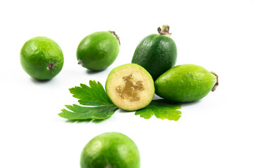 Composition tamplate with tropical feijoa acca sellowiana, pineapple guava fruit ripe and cut white isolated background