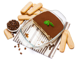 Traditional Italian Tiramisu dessert in glass baking dish isolatet on white background
