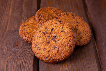 Round cookies with chocolate macro view on a wooden table
