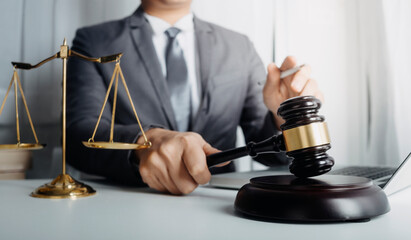 Business and lawyers discussing contract papers with brass scale on desk in office. Law, legal services, advice, justice and law concept picture with film grain effect