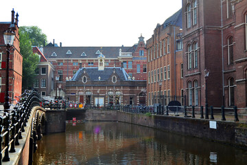 The University of Amsterdam (Dutch: Universiteit van Amsterdam) is a public university located in Amsterdam, Netherlands. Beautiful old building, canal and bicycle parking.