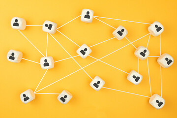 connections between people, social network concept with wooden blocks on colored background