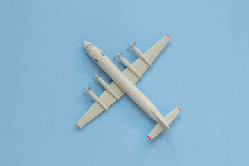 a toy plane on a bright colored background, the concept of resuming flights around the world after the coronavirus, restoring the finances of airlines and tour operators.