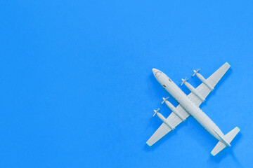 a toy plane on a bright colored background, the concept of resuming flights around the world after the coronavirus, restoring the finances of airlines and tour operators.