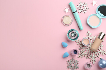 Flat lay composition with decorative cosmetic products on pink background, space for text. Winter care