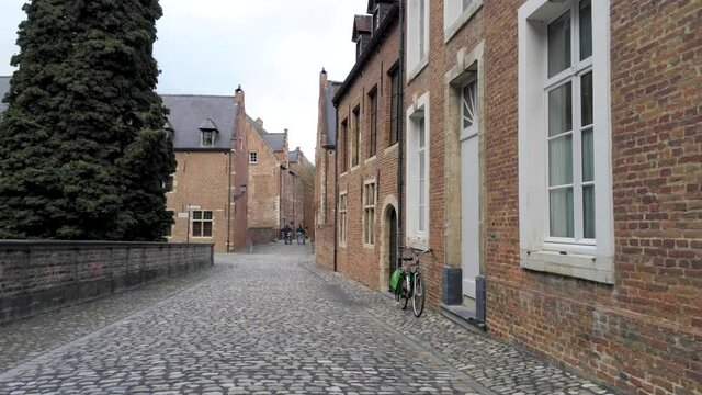 Walking in the beguinage (Groot Begijnhof) of Leuven, Belgium. Tracking shot
