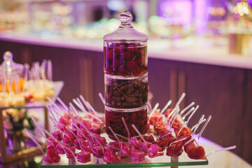 Beautifully decorated catering banquet table with variety of vegetables and different vegan vegetarian snacks on corporate christmas birthday party event or wedding celebration