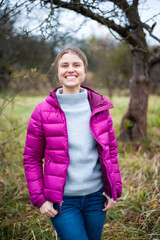 Fototapeta premium Beautiful blonde woman in autumn tourism clothes outdoor