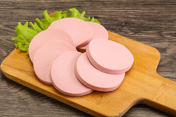 Sliced sausage snak over board