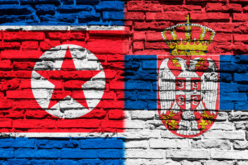 Flag of North Korea and Serbia on brick wall