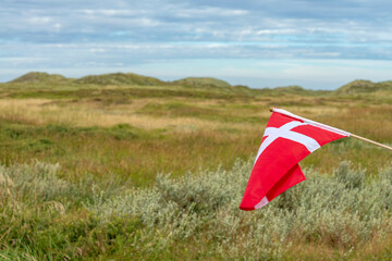 The Danish flag of Dannebrog and the Thy National Park in Northern Denmark.