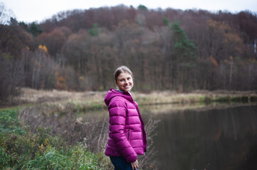 Beautiful blonde woman in autumn tourism clothes outdoor