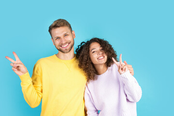 Man and african american woman standing on blue background