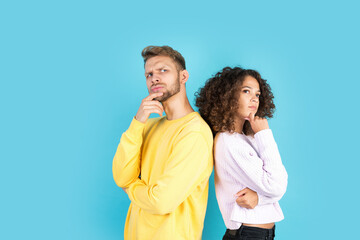 Two mixed race people standing on blue background