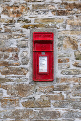 old red post box in wall