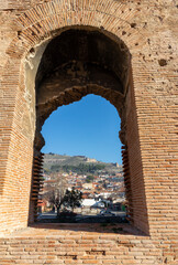 The ancient city of Pergamon on the hill can be seen from the window of the Bergama Red Basilica.