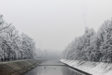 The Miljacka river in Sarajevo during the winter. In winter, Sarajevo has fog and pollution with little snow on the coast.