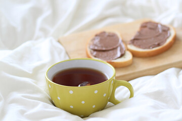tea in a green mug and nutella bread