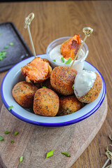 Croquettes with piquillo peppers and bechamel. Spanish vegetarian croquettes as a tapa dish with dipping sauce. 