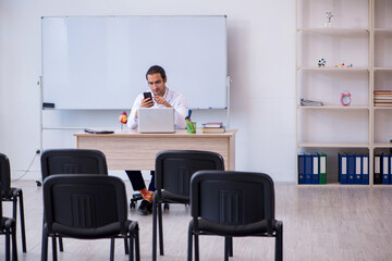 Young male doctor giving seminar in the classroom