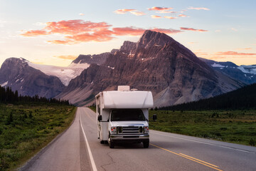 Scenic road in the Canadian Rockies during a vibrant sunny summer sunrise. White RV Driving on route. Taken in Icefields Parkway, Banff National Park, Alberta, Canada. - obrazy, fototapety, plakaty