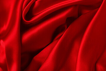 Red silk or satin luxury fabric texture can use as abstract background. Top view