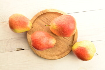 organic yellow-red pears, close-up, on a wooden table.