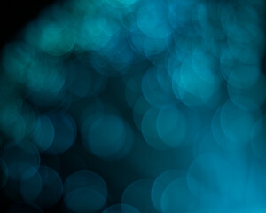 An abstract aqua colored blurred bokeh background with copy space