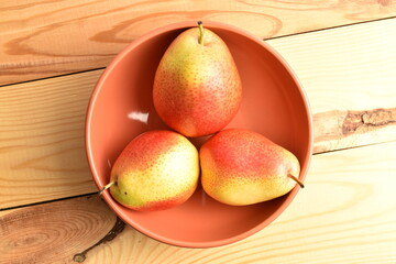 organic yellow-red pears, close-up, on a wooden table.
