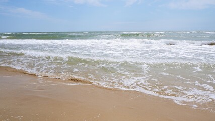 Fototapeta na wymiar Clear sea water, wave and sand beach.