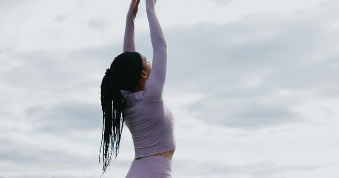 Concentration face African american woman doing yoga poses meditation in mountains. Harmony concentration activity nature healthy. Relaxation. Slow motion